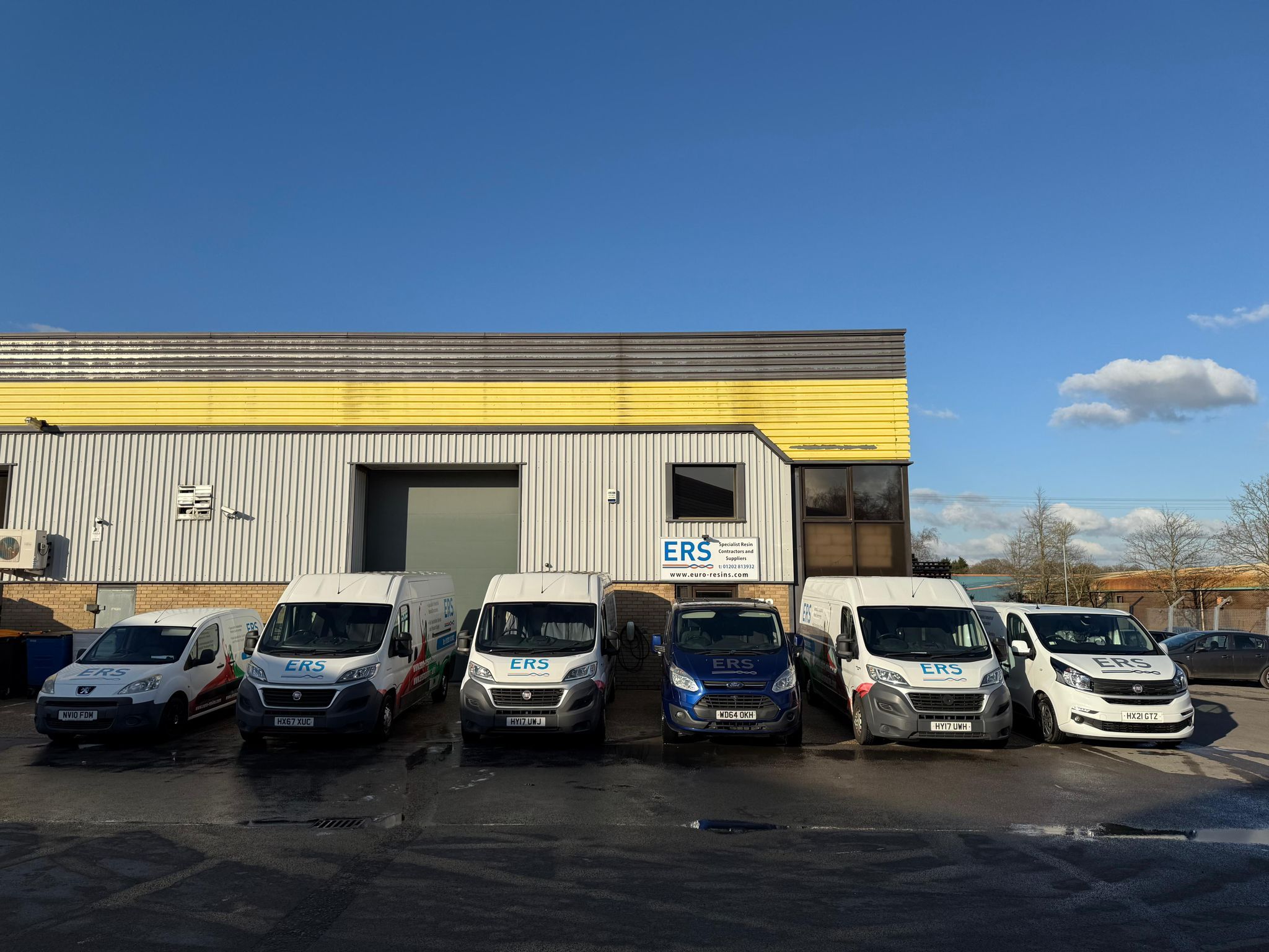 Photo of the Euro Resins building, with vans in front of it